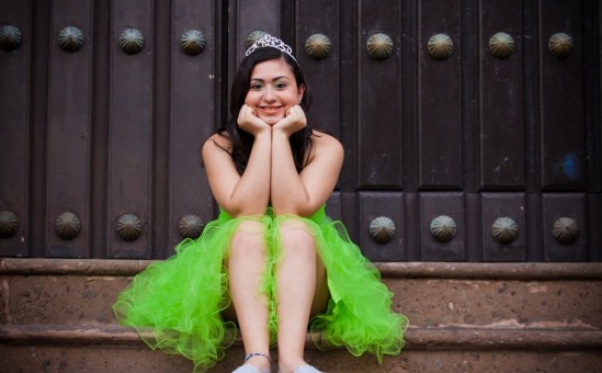 Quinceanera seated in stairs