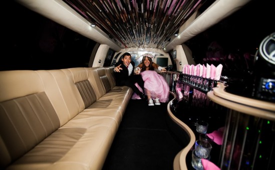 Quinceanera with chambelan in the limousine