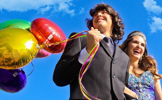 Quinceanera with chambelan and balloons