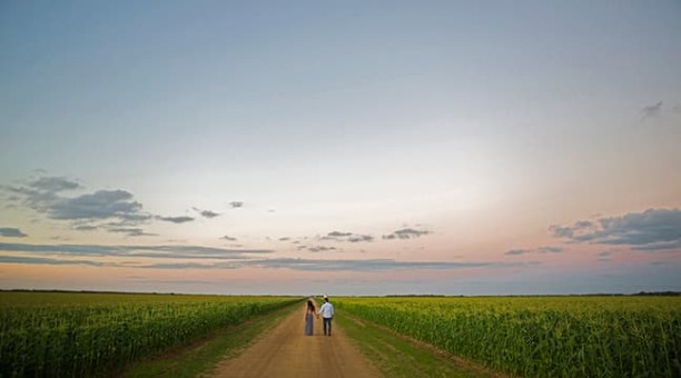Couple walking in a cornfield in Homestead