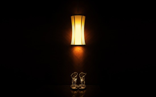 Wedding shoes in dark background under the lamp