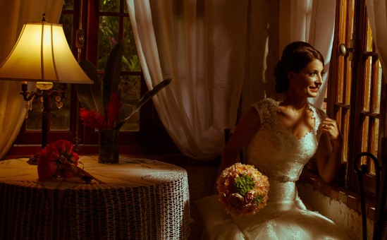 Bride looking at the window in Siesta Alegre Inn