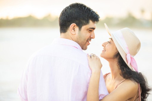 Indian couple at the beach in a romantic pose at the beach